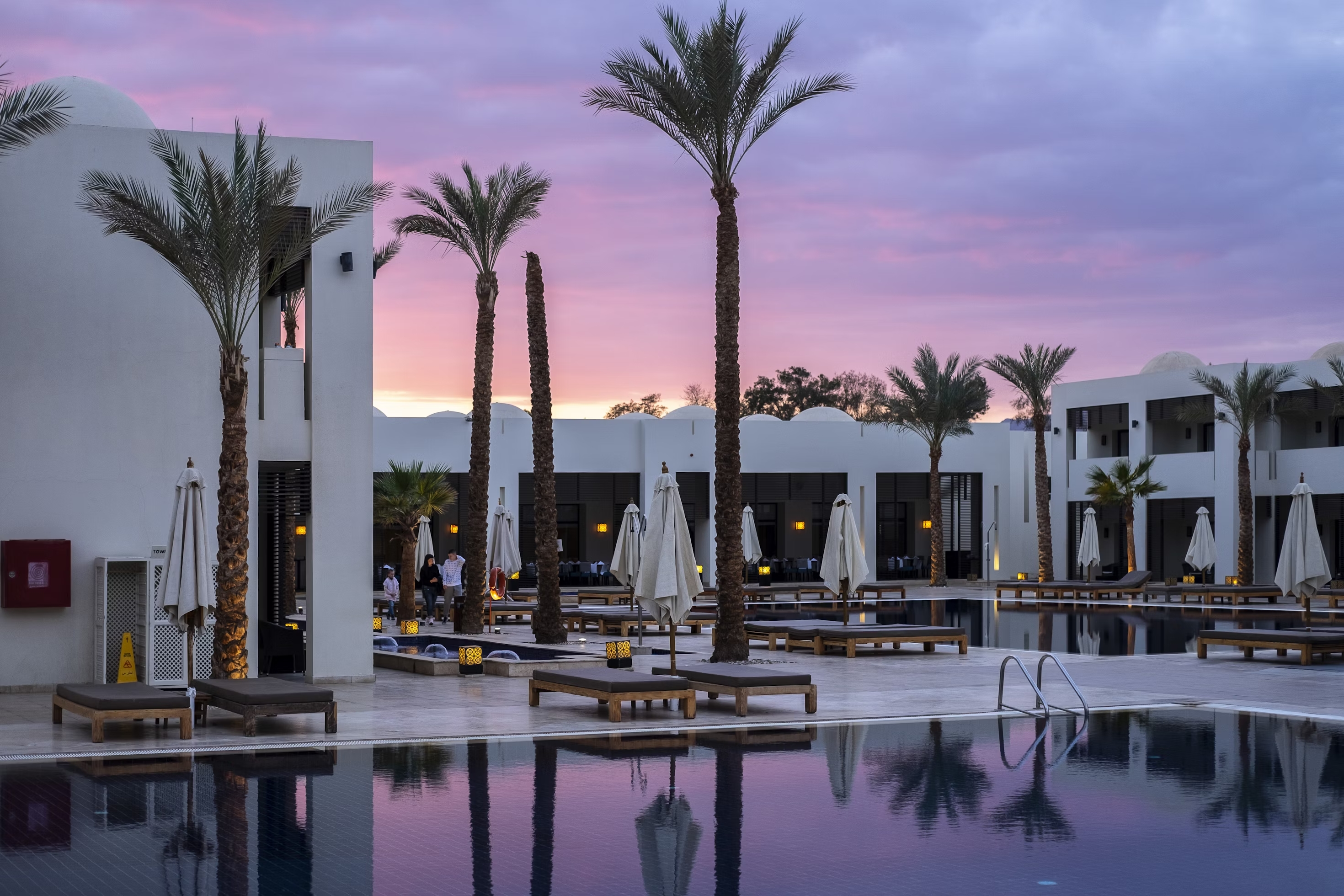 Luxury hotel with pool and palm trees